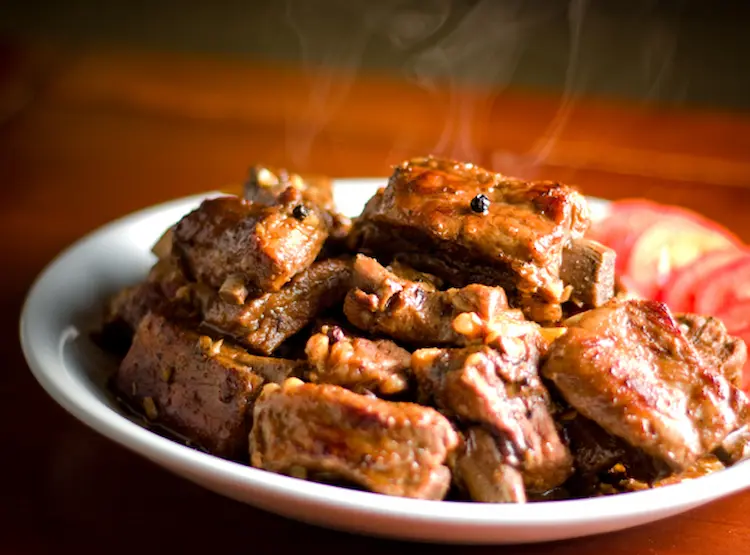 a plate of classic filipino pork ribs adobo