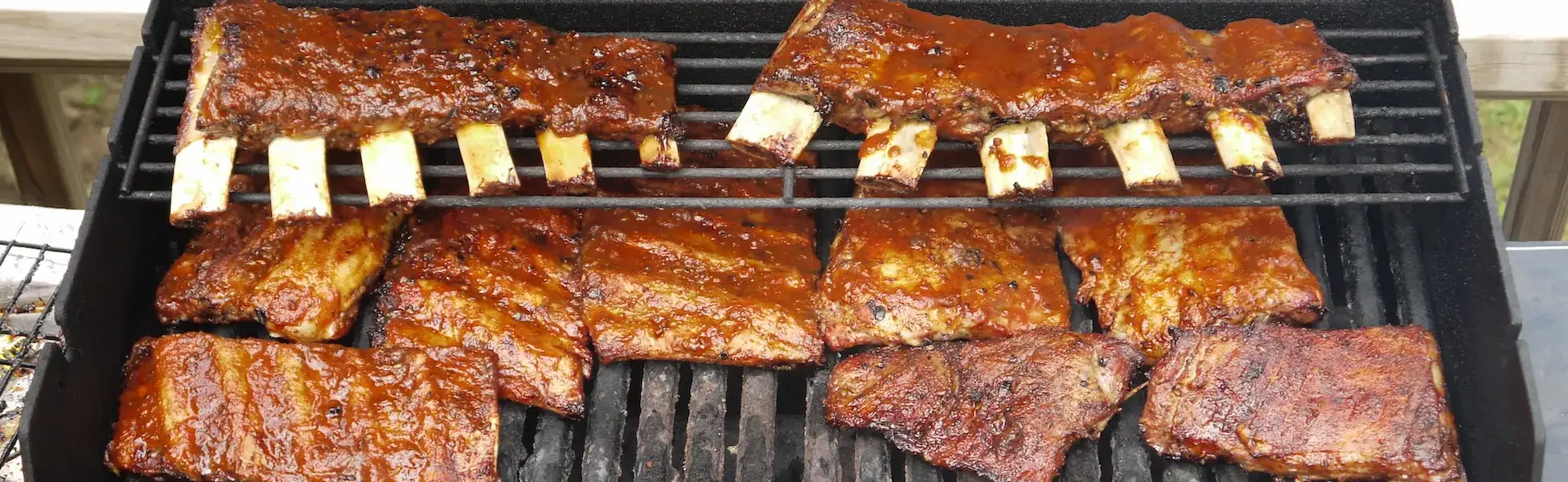 picture of a grill with ribs inside of it that are ready to be serve